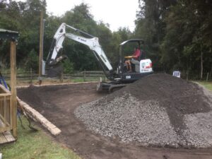 Bobcat excavator spreading recycled Millings on new RV pad